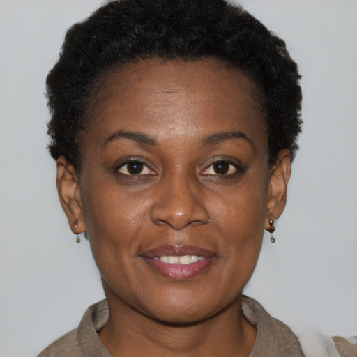 Joyful black adult female with short  brown hair and brown eyes