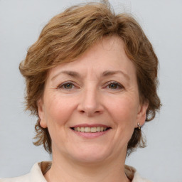 Joyful white adult female with medium  brown hair and grey eyes