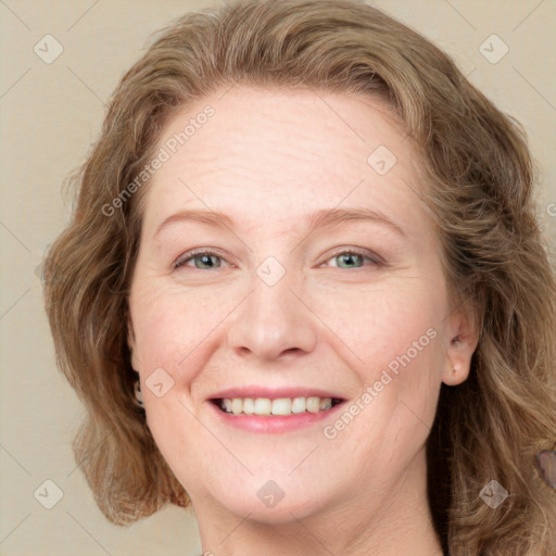 Joyful white adult female with medium  brown hair and blue eyes