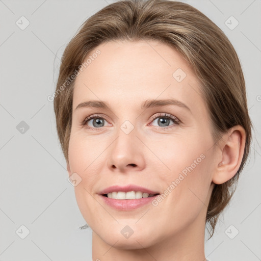 Joyful white young-adult female with medium  brown hair and grey eyes