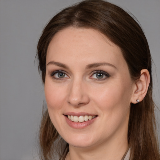 Joyful white young-adult female with medium  brown hair and grey eyes