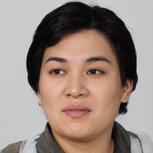 Joyful asian young-adult female with short  black hair and brown eyes