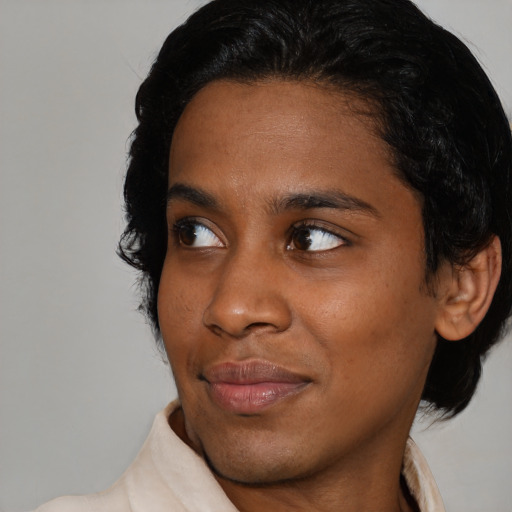 Joyful black young-adult female with medium  black hair and brown eyes