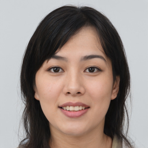 Joyful asian young-adult female with long  brown hair and brown eyes