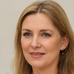 Joyful white adult female with long  brown hair and brown eyes