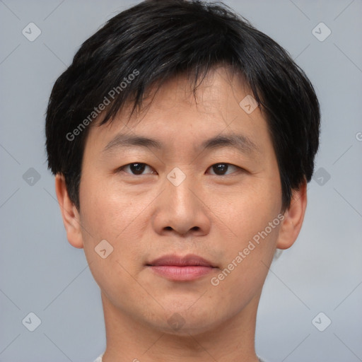 Joyful asian young-adult male with short  brown hair and brown eyes