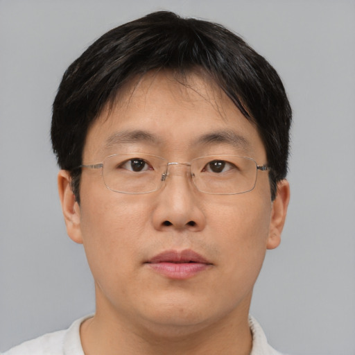 Neutral asian adult male with short  brown hair and brown eyes