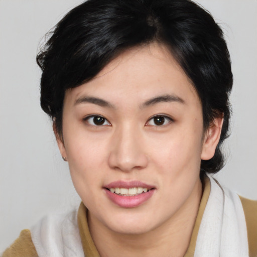 Joyful asian young-adult female with medium  brown hair and brown eyes