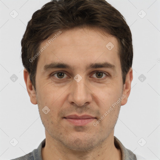 Joyful white adult male with short  brown hair and brown eyes