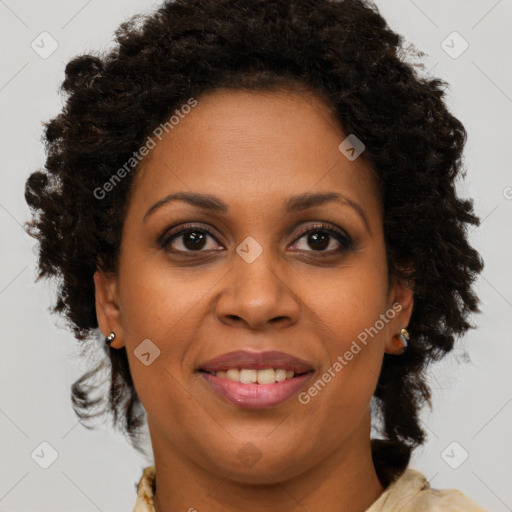 Joyful black adult female with medium  brown hair and brown eyes