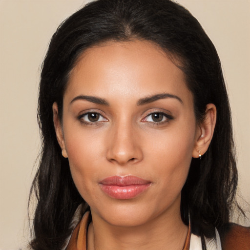 Joyful latino young-adult female with long  brown hair and brown eyes