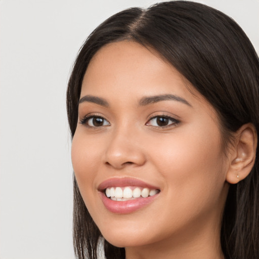 Joyful white young-adult female with long  black hair and brown eyes