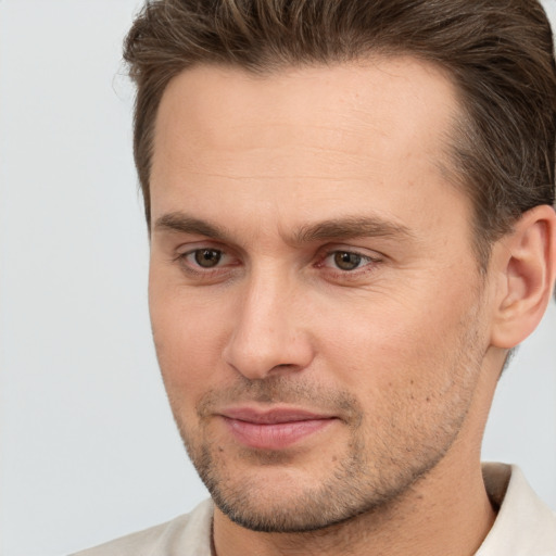 Joyful white adult male with short  brown hair and brown eyes