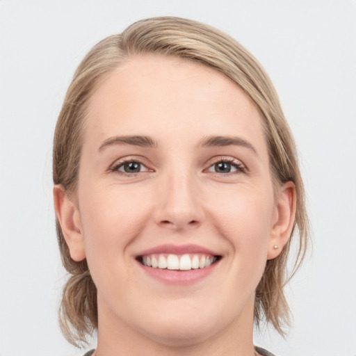 Joyful white young-adult female with medium  brown hair and blue eyes