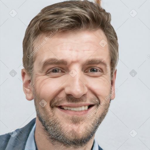 Joyful white adult male with short  brown hair and grey eyes