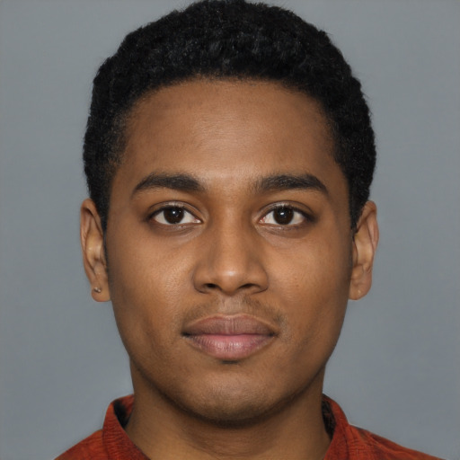 Joyful black young-adult male with short  brown hair and brown eyes