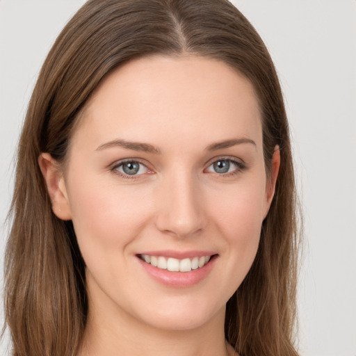 Joyful white young-adult female with long  brown hair and grey eyes