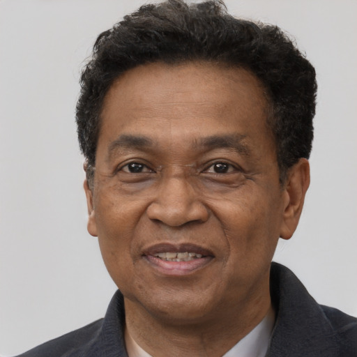 Joyful black adult male with short  brown hair and brown eyes