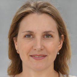 Joyful white adult female with medium  brown hair and grey eyes