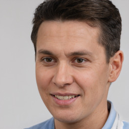 Joyful white adult male with short  brown hair and brown eyes