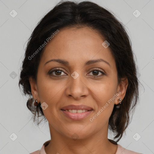 Joyful latino adult female with medium  brown hair and brown eyes