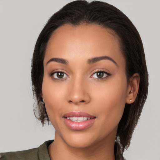 Joyful white young-adult female with medium  black hair and brown eyes