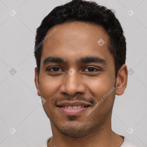 Joyful latino young-adult male with short  black hair and brown eyes