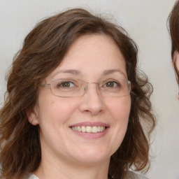 Joyful white adult female with medium  brown hair and brown eyes