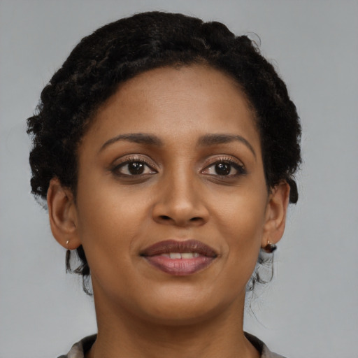 Joyful black young-adult female with short  brown hair and brown eyes