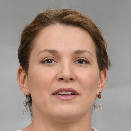 Joyful white adult female with medium  brown hair and grey eyes