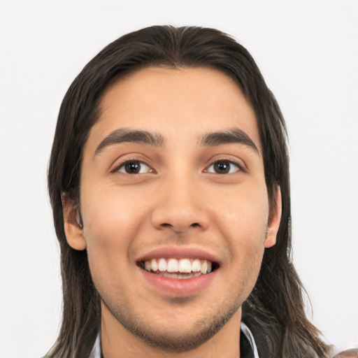 Joyful white young-adult male with long  black hair and brown eyes