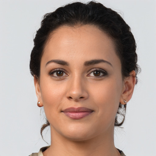 Joyful latino young-adult female with medium  brown hair and brown eyes