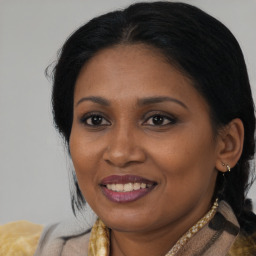 Joyful black adult female with medium  brown hair and brown eyes