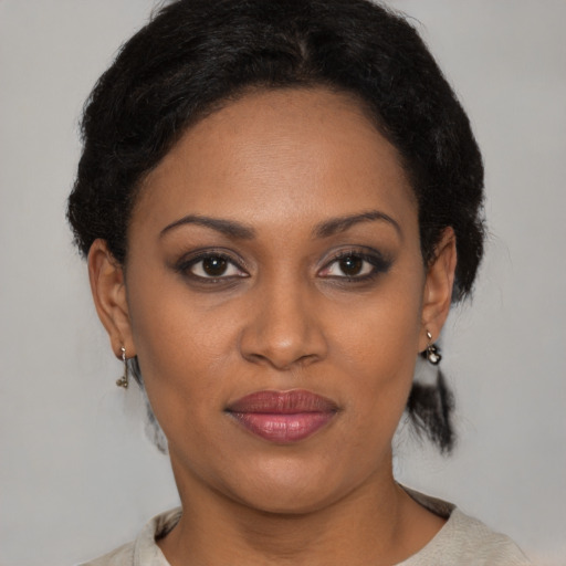 Joyful black young-adult female with medium  brown hair and brown eyes