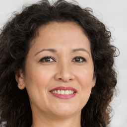 Joyful white adult female with long  brown hair and brown eyes