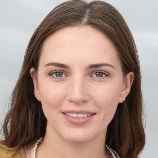 Joyful white young-adult female with long  brown hair and grey eyes