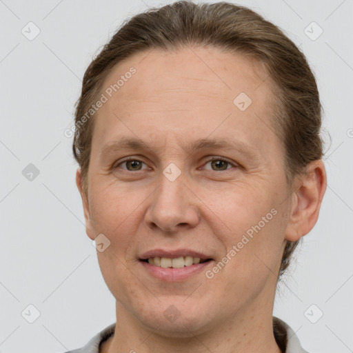 Joyful white adult female with short  brown hair and grey eyes