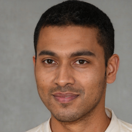 Joyful latino young-adult male with short  black hair and brown eyes