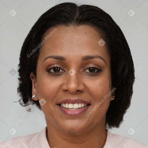Joyful black adult female with medium  brown hair and brown eyes