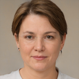 Joyful white adult female with medium  brown hair and grey eyes