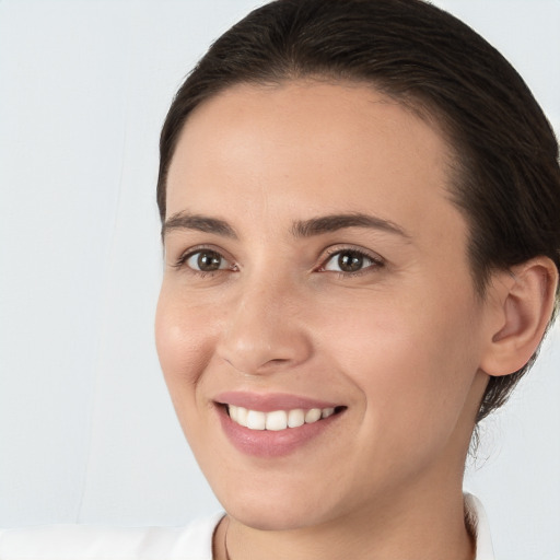 Joyful white young-adult female with medium  brown hair and brown eyes