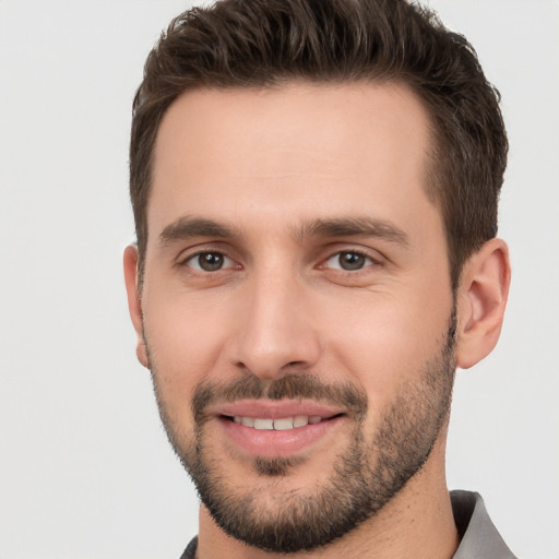 Joyful white young-adult male with short  brown hair and brown eyes