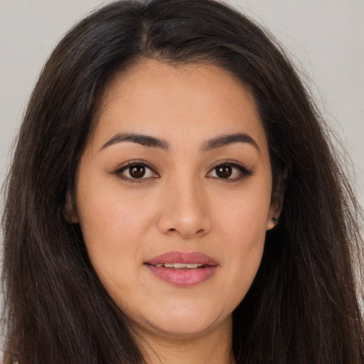 Joyful asian young-adult female with long  brown hair and brown eyes