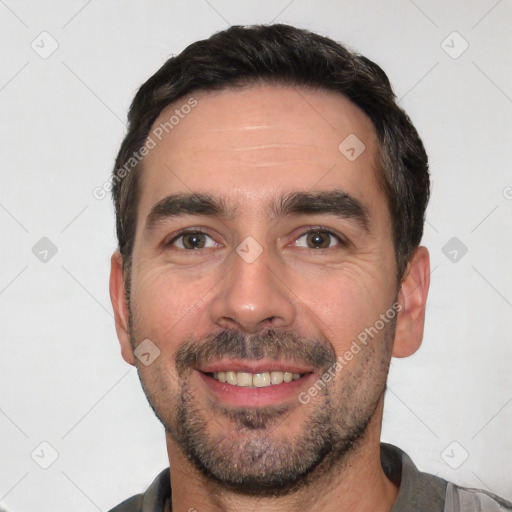 Joyful white young-adult male with short  black hair and brown eyes