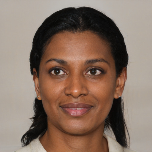 Joyful black young-adult female with medium  black hair and brown eyes