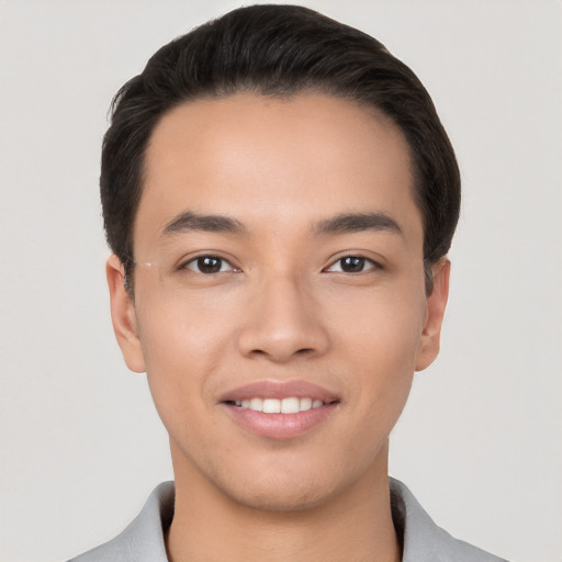 Joyful white young-adult male with short  black hair and brown eyes