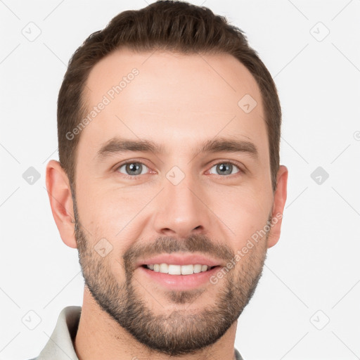 Joyful white young-adult male with short  brown hair and grey eyes