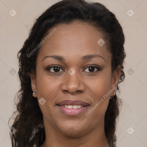 Joyful black young-adult female with long  brown hair and brown eyes