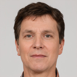 Joyful white adult male with short  brown hair and grey eyes