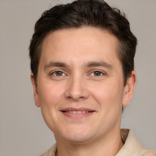 Joyful white adult male with short  brown hair and brown eyes